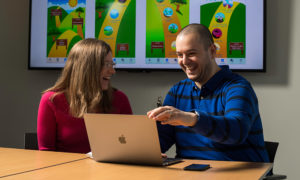 Christie Petrenko and Cristiano Tapparello working at computer