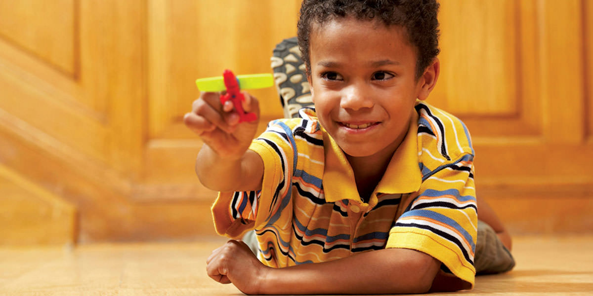 Child playing with toy airplane