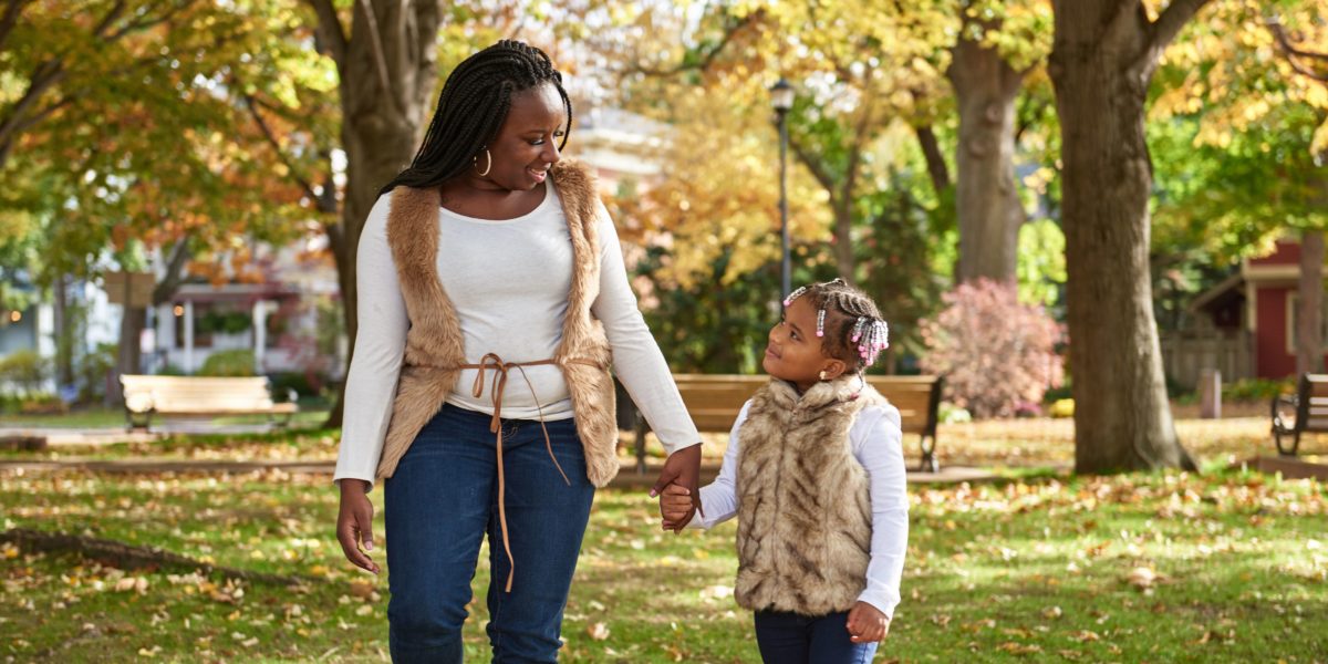 Mother and daughter holding hands