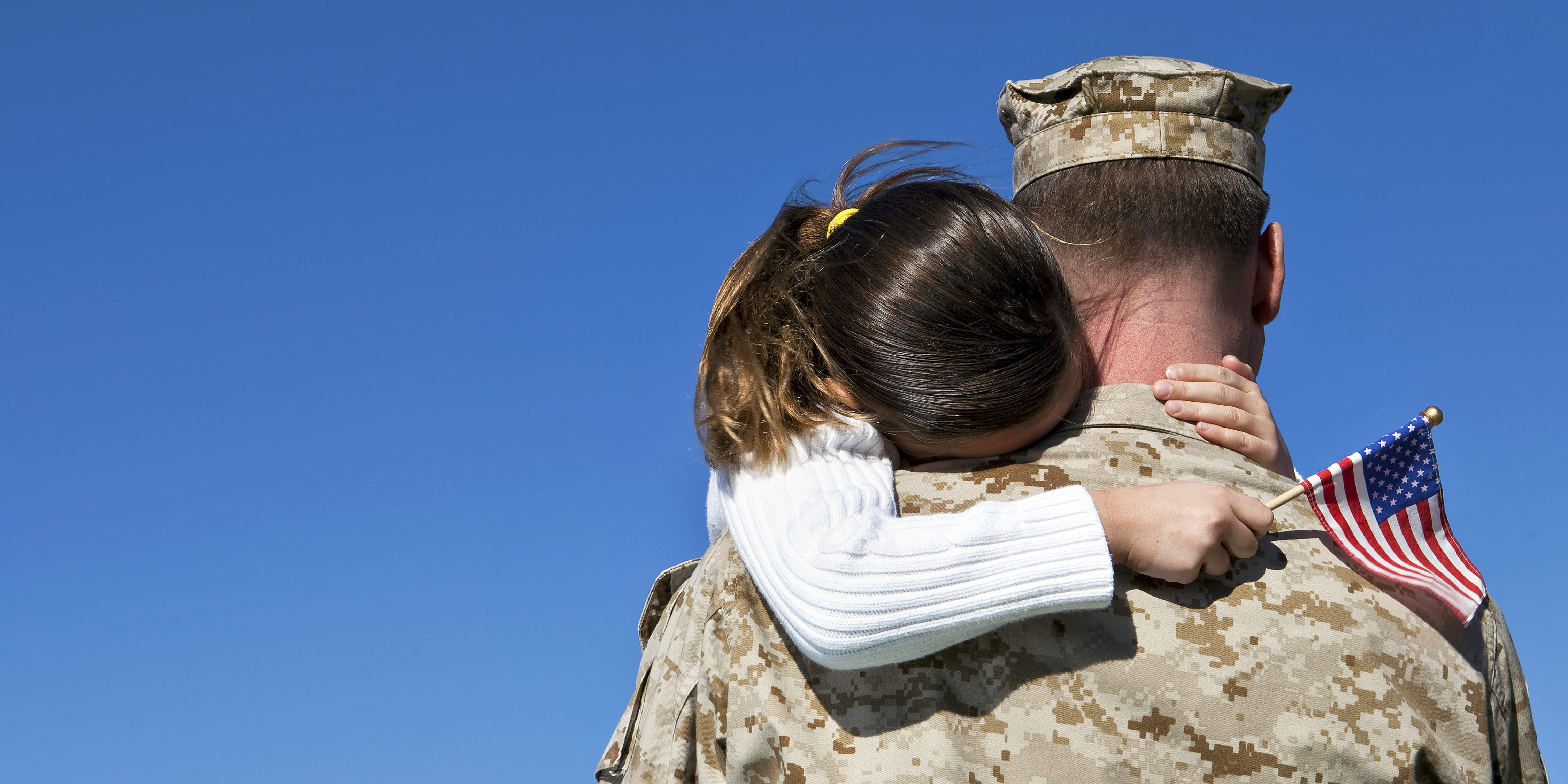 Solider holding daughter